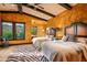 Bedroom with two beds, zebra rug, dark wood trim and scenic views from the adjacent windows at 42237 N 107Th Pl, Scottsdale, AZ 85262