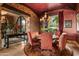 The dining room is illuminated by a chandelier with a stone wall, a dining table, and chairs at 42237 N 107Th Pl, Scottsdale, AZ 85262