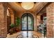 Grand foyer with stone walls, wrought iron doors, and custom tile flooring at 42237 N 107Th Pl, Scottsdale, AZ 85262