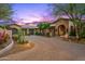 Charming home with brick driveway, mature landscaping, and arched entrance at 42237 N 107Th Pl, Scottsdale, AZ 85262