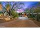 Lush desert landscaping highlights the front exterior of this beautiful home with a brick driveway at 42237 N 107Th Pl, Scottsdale, AZ 85262