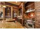 A gourmet kitchen highlights a stainless range and hood alongside custom cabinetry and stone elements at 42237 N 107Th Pl, Scottsdale, AZ 85262