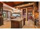 A gourmet kitchen showcases an oversized granite-topped island and connects to a stone accent wall with exterior views at 42237 N 107Th Pl, Scottsdale, AZ 85262