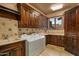 Large laundry room with custom cabinetry and modern washer and dryer at 42237 N 107Th Pl, Scottsdale, AZ 85262