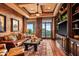 Comfortable living room with leather furniture, built-in shelving, and a view of the outdoors at 42237 N 107Th Pl, Scottsdale, AZ 85262