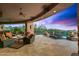 Expansive covered patio with desert views, pool, fire features, and seating at 42237 N 107Th Pl, Scottsdale, AZ 85262