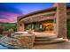 An expansive outdoor patio features a water feature, built-in fire bowls, and a seating area at 42237 N 107Th Pl, Scottsdale, AZ 85262