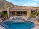 Backyard view of a private pool with stone accents and outdoor seating area with beautiful desert views at 42237 N 107Th Pl, Scottsdale, AZ 85262