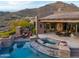 Backyard oasis with pool, spa, fire features, and covered patio at 42237 N 107Th Pl, Scottsdale, AZ 85262