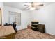 Bedroom with a ceiling fan, dresser, wheelchair, and a bed, offering functional space at 4401 W Lewis Ave, Phoenix, AZ 85035