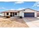 Charming single-story home featuring a two-car garage and desert landscaping at 4401 W Lewis Ave, Phoenix, AZ 85035