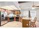 Kitchen featuring stainless steel refrigerator, modern appliances, and an island with seating at 4401 W Lewis Ave, Phoenix, AZ 85035