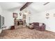 Cozy living room showcasing a stone fireplace, ceiling fan, and comfortable seating at 4401 W Lewis Ave, Phoenix, AZ 85035