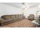 Spacious living room with neutral carpet, a ceiling fan, and comfortable seating at 4401 W Lewis Ave, Phoenix, AZ 85035