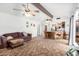 Open-concept living room featuring ceiling fans and views into the kitchen area at 4401 W Lewis Ave, Phoenix, AZ 85035