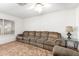 Bright living room features a large window, comfortable seating, and a ceiling fan at 4401 W Lewis Ave, Phoenix, AZ 85035