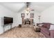 Vaulted ceiling living room with fireplace and a large flat screen television at 4401 W Lewis Ave, Phoenix, AZ 85035