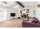 Cozy living room with stone fireplace, vaulted ceilings, and ceiling fan at 4401 W Lewis Ave, Phoenix, AZ 85035