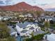 Aerial view of an elegant neighborhood showcasing a beautifully landscaped home and mountain views at 4716 N Dromedary Rd, Phoenix, AZ 85018