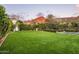 Lush backyard with grass and privacy hedges overlooking mountain views at 4716 N Dromedary Rd, Phoenix, AZ 85018