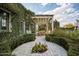 Landscaped backyard patio with dining area covered by a pergola attached to a brick and ivy covered building at 4716 N Dromedary Rd, Phoenix, AZ 85018