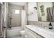 Modern bathroom featuring a bathtub and shower combination, along with a stylish vanity and marble countertop at 4716 N Dromedary Rd, Phoenix, AZ 85018