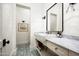 Stylish powder room with shiplap walls, patterned tile floors, and a vanity with marble countertop at 4716 N Dromedary Rd, Phoenix, AZ 85018