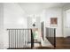 Elegant hallway with white shiplap walls, dark wood floors, and stylish black railings at 4716 N Dromedary Rd, Phoenix, AZ 85018