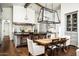 Spacious kitchen and dining area with wooden table, sleek countertops, and modern lighting fixtures at 4716 N Dromedary Rd, Phoenix, AZ 85018