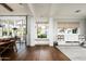 Bright living room featuring hardwood floors, built-in storage, and access to an outdoor patio at 4716 N Dromedary Rd, Phoenix, AZ 85018