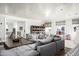 Spacious living room features a large sectional sofa, custom shelving, and a view of the playroom at 4716 N Dromedary Rd, Phoenix, AZ 85018