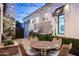 Cozy outdoor kitchen and dining area with built-in grill, string lights, and covered patio at 4716 N Dromedary Rd, Phoenix, AZ 85018