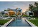 Elegant pool with water features, set against the backdrop of a beautiful two-story house at 4716 N Dromedary Rd, Phoenix, AZ 85018