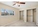 Spacious bedroom with built in closet shelving and outdoor view at 5013 W Orchid Ln, Glendale, AZ 85302