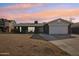 Charming single-story home with a well-manicured lawn and attached two-car garage at 5013 W Orchid Ln, Glendale, AZ 85302