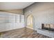 Inviting living room featuring a brick fireplace and built-in shelving at 5013 W Orchid Ln, Glendale, AZ 85302