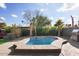 Relaxing backyard with pool, built in seating, and BBQ station at 5013 W Orchid Ln, Glendale, AZ 85302