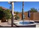 Private backyard featuring a cozy round pool, desert landscaping, and shade at 5622 E Emerald Cir, Mesa, AZ 85206