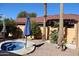 Relaxing backyard featuring a round pool, desert landscaping, and shady umbrella at 5622 E Emerald Cir, Mesa, AZ 85206