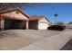 Large driveway leading to a two-car garage, providing ample parking space at 5622 E Emerald Cir, Mesa, AZ 85206