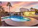 Backyard pool with patio area, lush greenery, and a picturesque sunset view at 5761 E Tierra Buena Ln, Scottsdale, AZ 85254