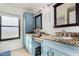 Bathroom with blue cabinetry, granite countertops, and double sink vanity at 5761 E Tierra Buena Ln, Scottsdale, AZ 85254