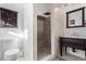 Elegant bathroom featuring a custom tile shower, dark wood vanity, and stylish fixtures at 5761 E Tierra Buena Ln, Scottsdale, AZ 85254