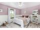 Comfortable bedroom has soft pink walls, white trim, and plenty of natural light at 5761 E Tierra Buena Ln, Scottsdale, AZ 85254