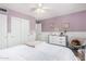 Calm bedroom with a white comforter, sliding closet, and soft lilac walls at 5761 E Tierra Buena Ln, Scottsdale, AZ 85254