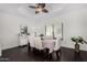 Bright dining room with a decorative ceiling fan, dark hardwood floors, and a large window at 5761 E Tierra Buena Ln, Scottsdale, AZ 85254