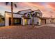 Charming two-story home with a fountain, red tile roof, and desert landscape in the front yard at 5761 E Tierra Buena Ln, Scottsdale, AZ 85254