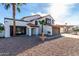 Charming two-story home with a fountain, red tile roof, and desert landscape in the front yard at 5761 E Tierra Buena Ln, Scottsdale, AZ 85254