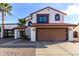 Charming two-story home with a red tile roof, two car garage, and a low maintenance desert landscape at 5761 E Tierra Buena Ln, Scottsdale, AZ 85254