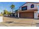 Charming two-story home featuring a terracotta tile roof, a spacious driveway and beautiful desert landscaping at 5761 E Tierra Buena Ln, Scottsdale, AZ 85254